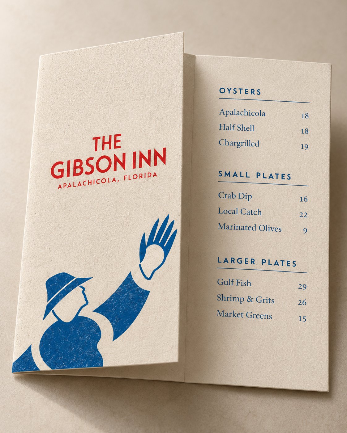 Folded Gibson Inn menu with the oysterman reaching up on the cover in blue and the name in red, opened to oysters, small plates and larger plates